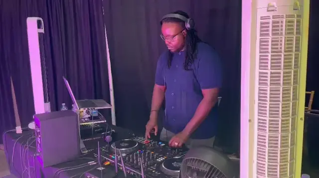 Rubicon's DJ at the controller in a purple-lit booth